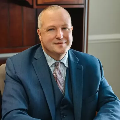 Attorney Luke Woods seated at his desk