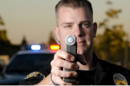 officer with preliminary breath test machine
