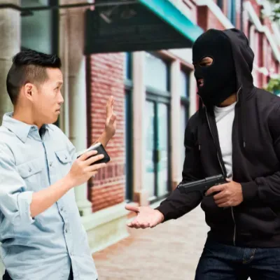 Man holding up person with gun